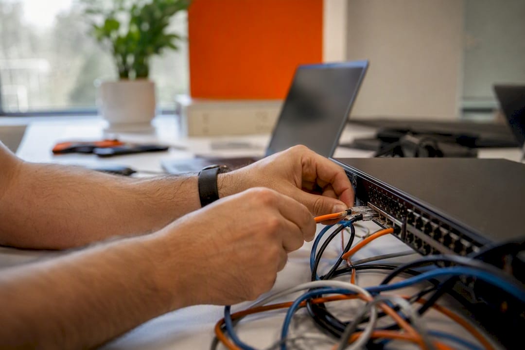 Hands connecting cables for system integration